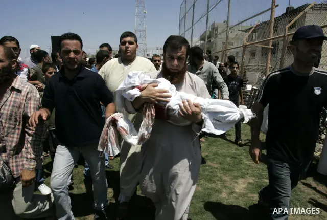 A Palestinian man carries the body of two-year-old boy Malek Sha'at during his funeral in Rafah in the southern Gaza Strip August 19, 2011. Israeli fighter jets bombed Gaza, killing a teenager and injuring five people, i...