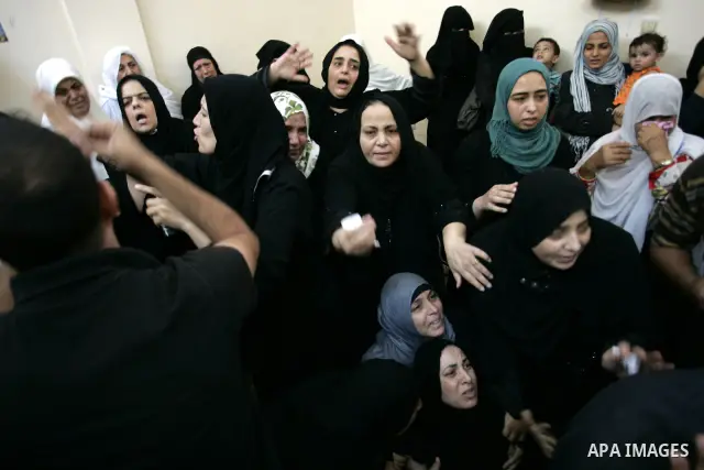 Palestinian relatives mourn during the funeral of the militant Kamal al-Nayrab, secretary-general of the Gaza-based group the Popular Resistance Committees (PRC), in the Rafah refugee camp, southern Gaza Strip, on August...