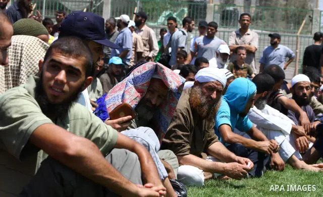Palestinians next to the bodies of Kamal al-Nairab, the leader of an armed Palestinian faction, and other members during their funeral in Rafah in the southern Gaza Strip August 19, 2011. An Israeli air strike killed the...