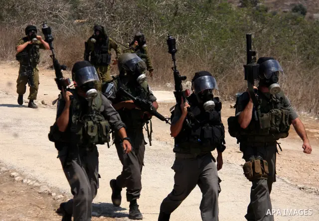 Israeli soldiers stand guard during clashes with Palestinian demonstrators following a protest against the closure of a road during the second Intifada by Jewish settlers from the nearby settlement of Kadumim on August 1...