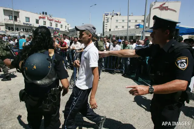Israeli police and riot police keep back a crowd of Palestinian Muslims who push to break past barricades at the Damascus gate (not seen) as a police water cannon sprays the crowds with a 'skunk' liquid on 19 August 2011...