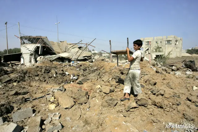 A Palestinian boy walks at the site of an overnight Israeli air raid in Khan Yunis in the southern Gaza Strip on August 20, 2011 on a third day of escalating Israeli-Palestinian tensions. Photo by Abed Rahim Khatib