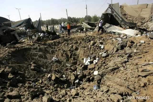 Palestinians inspect the site of an overnight Israeli air raid in Khan Yunis in the southern Gaza Strip on August 20, 2011 on a third day of escalating Israeli-Palestinian tensions. Photo by Abed Rahim Khatib