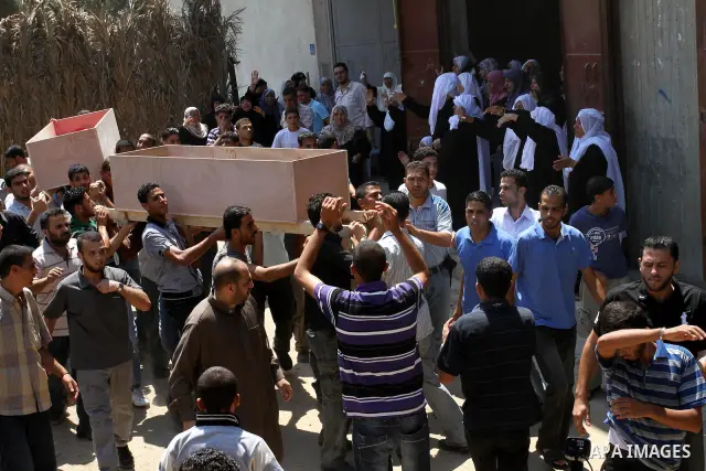 Palestinian mourners carry the coffins of Moataz Qouriqa, a commander of Islamic Jihad's Al-Quds Brigade, and his brother during their funeral in Gaza City on August 20, 2011 after Israeli planes launched air strikes in...