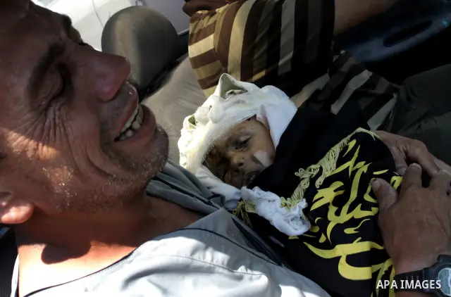 A Palestinian man carries the body of two-year-old boy Islam Qreqa during a funeral in Gaza City on August 20, 2011. Palestinians said at least nine militants have died in multiple Israeli strikes, as well as two childre...