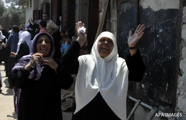Palestinian relatives attend the funeral procession of Moataz Qreqa, Monzer Qreqa and five-year-old Islam Moataz Qreqa in Al Shejaeiya in the east of Gaza City, on Aug. 20, 2011. Three Palestinians were killed one of the...