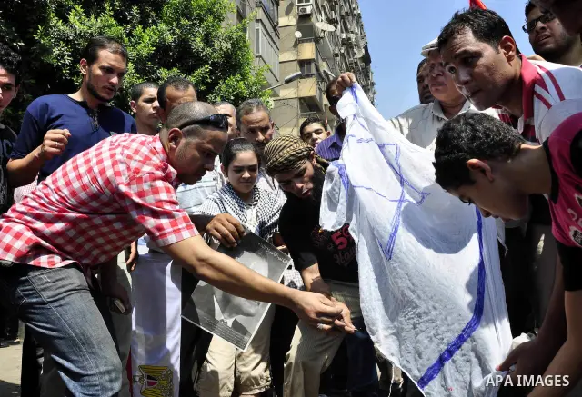 Egyptian demonstrators burn an Israeli flag during a protest outside the Israeli embassy in Cairo on August 20, 2011. Egypt decided to recall its ambassador from Israel to protest the deaths of policemen killed on the bo...