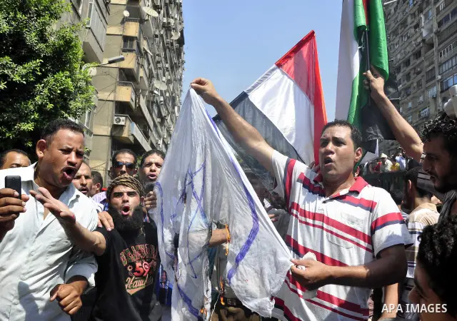 Egyptian demonstrators burn an Israeli flag during a protest outside the Israeli embassy in Cairo on August 20, 2011. Egypt decided to recall its ambassador from Israel to protest the deaths of policemen killed on the bo...