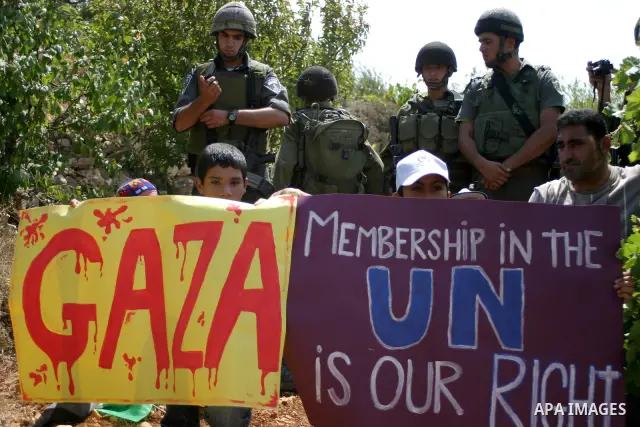 Israeli soldiers stand guard as Palestinians demonstrate along with left-wing Israelis and foreign peace activists in Beit Omar, near the West Bank city of Hebron on August 20, 2011 for the creation of a Palesitnian stat...