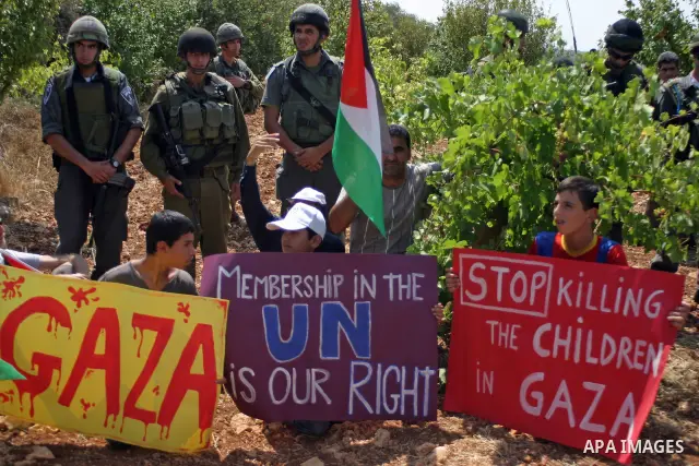 Israeli soldiers stand guard as Palestinians demonstrate along with left-wing Israelis and foreign peace activists in Beit Omar, near the West Bank city of Hebron on August 20, 2011 for the creation of a Palesitnian stat...