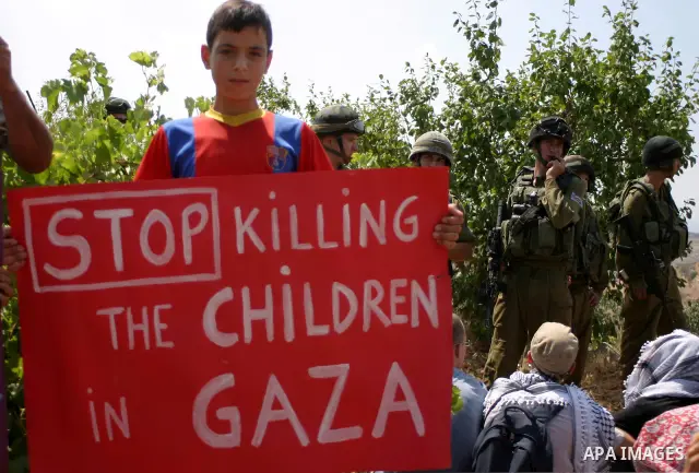 Israeli soldiers stand guard as Palestinians demonstrate along with left-wing Israelis and foreign peace activists in Beit Omar, near the West Bank city of Hebron on August 20, 2011 for the creation of a Palesitnian stat...
