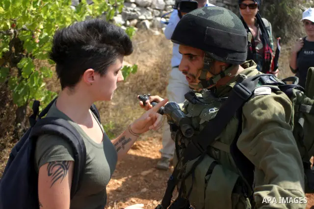 A demonstrator scuffle with Israeli soldiers during a demonstration by locals, left-wing Israelis, foreigner peace activists in Beit Omar, near the West Bank city of Hebron on August 20, 2011 against the latest Israeli a...