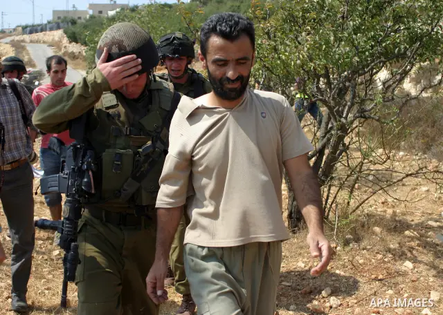 Israeli soldiers detain protesters during a demonstration by locals, left-wing Israelis, foreigner peace activists in Beit Omar, near the West Bank city of Hebron on August 20, 2011 against the latest Israeli air strikes...