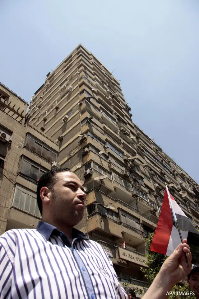 An Egyptian protester shouts anti-Israeli slogans as others wave an Egyptian flag, during a protest in front of the Israeli embassy in Cairo, Egypt, Sunday, Aug. 21, 2011. Hundreds of Egyptians protest the deaths of Egyp...