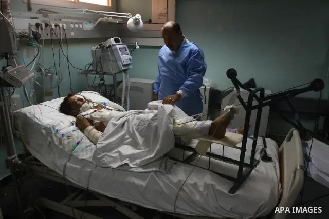 Ebrahim Al-Zaza, fifteen-years-old wounded Palestinian boy, receives a treatment inside the intensive care unit in al-Shefa hospital in Gaza City, Aug. 21, 2011. So far 15 Palestinians including three children were kille...