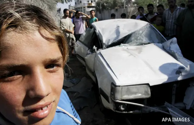 Palestinians inspect the damage at a Hamas training camp following an Israeli airstrike in Gaza City, Sunday, on Aug. 21, 2011. Militants in the Hamas-ruled Gaza Strip bombarded southern Israel with rockets and mortars S...