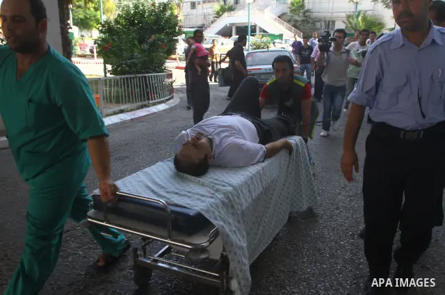 A Palestinian man is brought into a hospital following an Israeli attack on Gaza City on August 21, 2011. Photo by Ashraf Amra