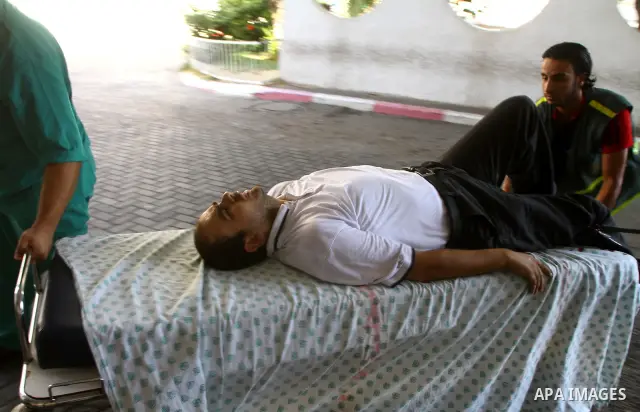 A Palestinian man is brought into a hospital following an Israeli attack on Gaza City on August 21, 2011. Photo by Ashraf Amra