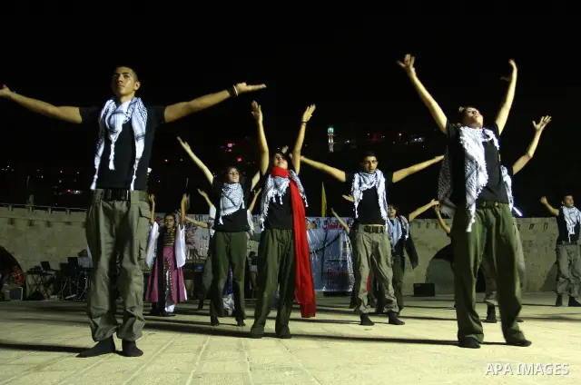 Palestinian dancers perform the popular 'Dabka' during a celebration in solidarity with the Palestinian prisoners inside the Israeli jails in the West Bank city of Nablus, Aug. 20, 2011. Photo by Wagdi Eshtayah