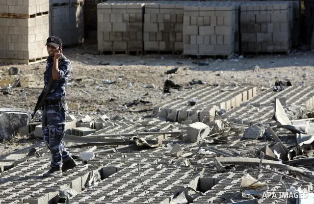 A Hamas security man inspects the damage at a Hamas training camp following an Israeli air-strike in Gaza City, Sunday, Aug. 21, 2011. Militants in the Hamas-ruled Gaza Strip bombarded southern Israel with rockets and mo...