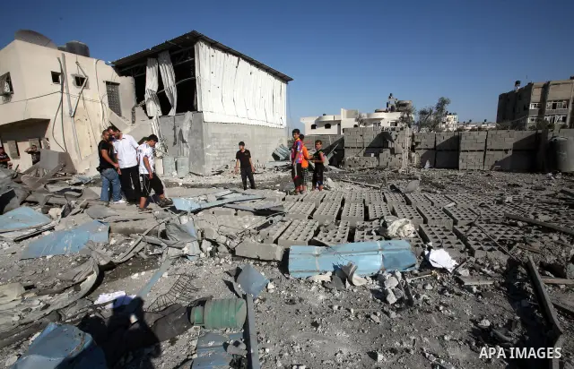 Palestinians inspect the damage at a Hamas training camp following an Israeli air-strike in Gaza City, Sunday, Aug. 21, 2011. Militants in the Hamas-ruled Gaza Strip bombarded southern Israel with rockets and mortars Sun...