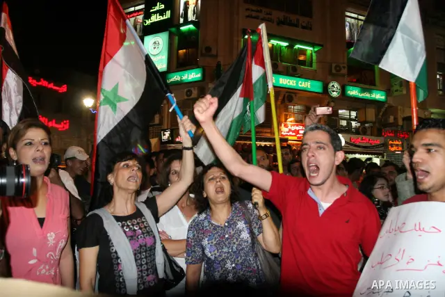 Palestinians take part in a protest against Israeli attacks over Gaza Strip in the West Bank city of Ramallah on Aug. 21, 2011. Photo by Issam Rimawi