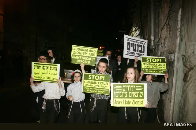 Ultra Orthodox Haredi Jews of the Neturei Karta group take part in a protest against Israeli attacks over Gaza Strip in the west of Jerusalem on Aug. 21, 2011. Photo by Mahfouz Abu Turk