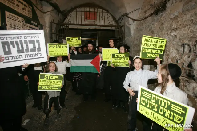 Ultra Orthodox Haredi Jews of the Neturei Karta group take part in a protest against Israeli attacks over Gaza Strip in the west of Jerusalem on Aug. 21, 2011. Photo by Mahfouz Abu Turk