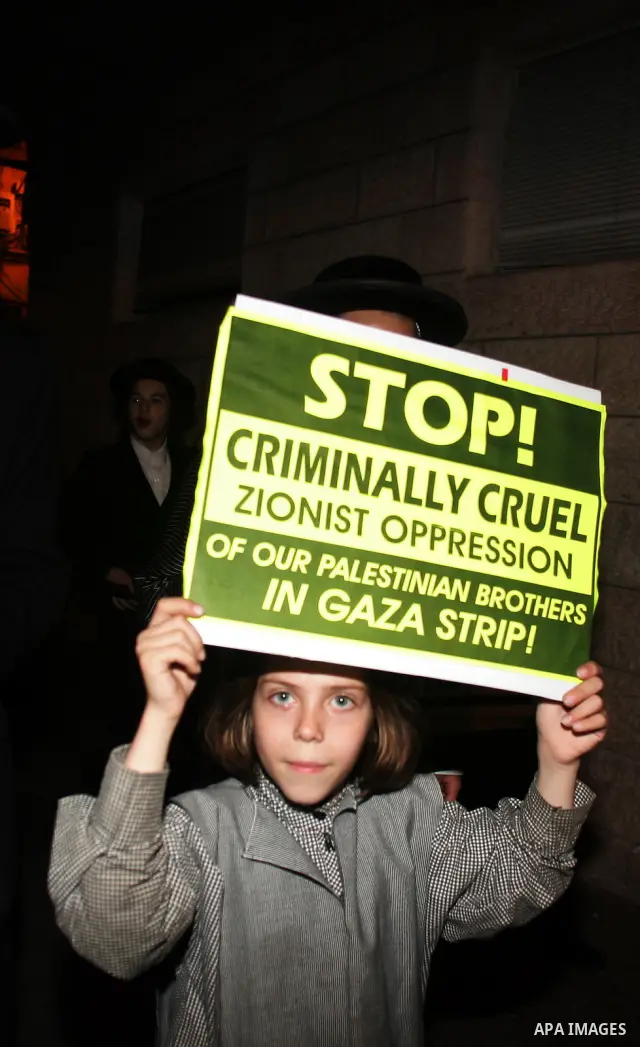 Ultra Orthodox Haredi Jews of the Neturei Karta group take part in a protest against Israeli attacks over Gaza Strip in the west of Jerusalem on Aug. 21, 2011. Photo by Mahfouz Abu Turk