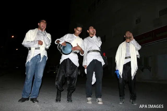 Palestinians youths 'Mesaharaty' use a traditional drum to wake up people for their Suhoor, in the West Bank city Ramallah, on, Aug. 22, 2011. Muslims throughout the world are celebrating the holy fasting month of Ramada...