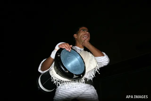 Palestinians youths 'Mesaharaty' use a traditional drum to wake up people for their Suhoor, in the West Bank city Ramallah, on, Aug. 22, 2011. Muslims throughout the world are celebrating the holy fasting month of Ramada...