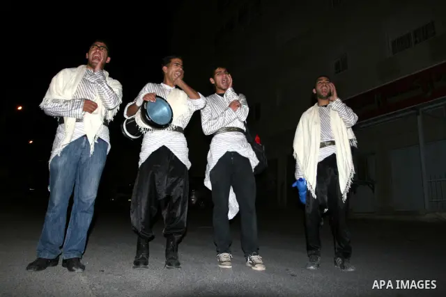 Palestinians youths 'Mesaharaty' use a traditional drum to wake up people for their Suhoor, in the West Bank city Ramallah, on, Aug. 22, 2011. Muslims throughout the world are celebrating the holy fasting month of Ramada...