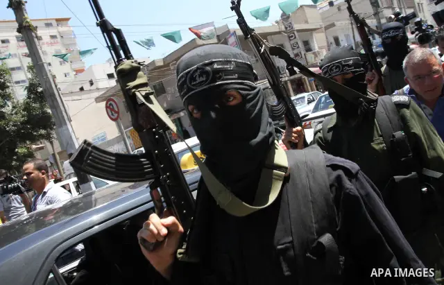 Palestinian militants of the Nasser Salah al-Din Brigades the military wing of the Popular Resistance Committees take part in a press conference, in Gaza city on Aug. 22, 2011 to announce a temporary halt of rocket fire...