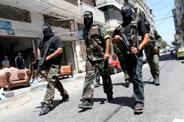 Palestinian militants of the Nasser Salah al-Din Brigades the military wing of the Popular Resistance Committees take part in a press conference, in Gaza city on Aug. 22, 2011 to announce a temporary halt of rocket fire...