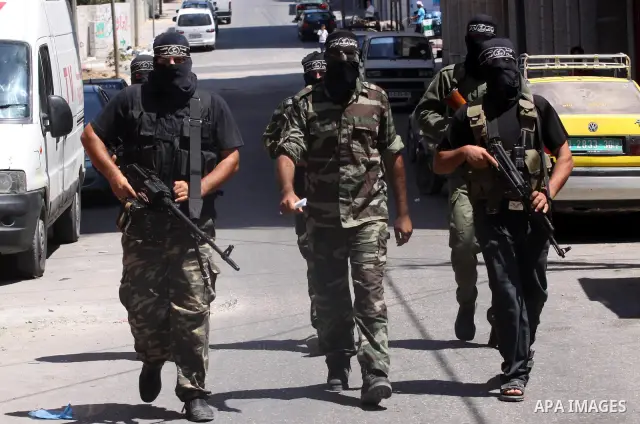 Palestinian militants of the Nasser Salah al-Din Brigades the military wing of the Popular Resistance Committees take part in a press conference, in Gaza city on Aug. 22, 2011 to announce a temporary halt of rocket fire...
