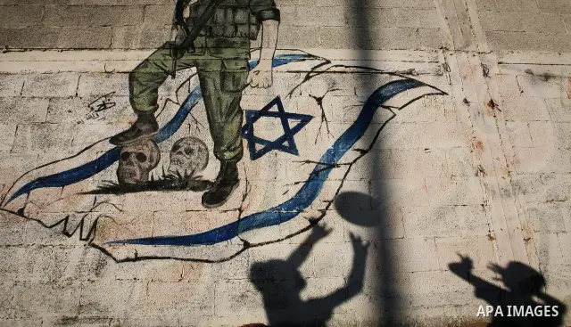 Palestinian children's shadows on a wall with a mural depicting a Palestinian fight and an Israeli flag in the Jabaliya Refugee Camp in northern Gaza Strip on 22 August 2011 Reports state that Palestinian militants fired...