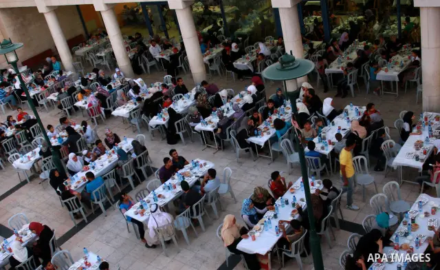Palestinians take part in the Central Ramadan breakfast for the first orphanage, organized by the United Arab Emirates State charity , in the West Bank city of Nablus, monday Aug . 22,2011. Muslims throughout the world a...