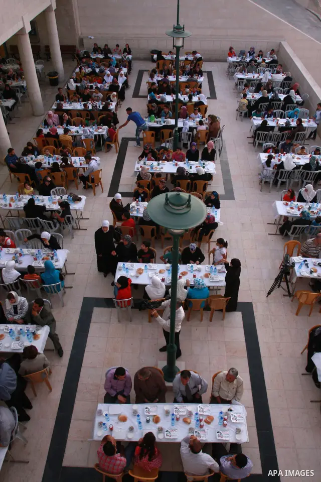 Palestinians take part in the Central Ramadan breakfast for the first orphanage, organized by the United Arab Emirates State charity , in the West Bank city of Nablus, monday Aug . 22,2011. Muslims throughout the world a...