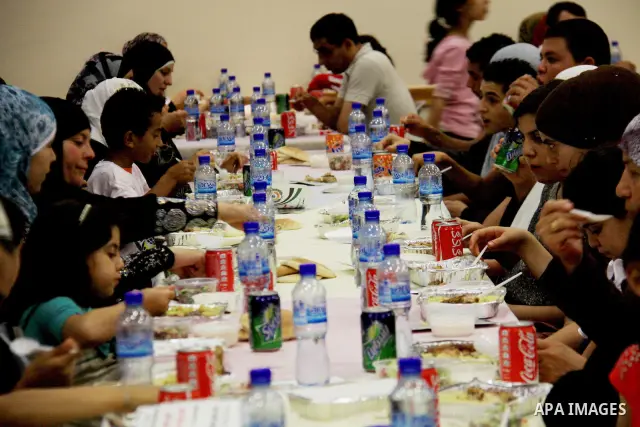 Palestinians take part in the Central Ramadan breakfast for the first orphanage, organized by the United Arab Emirates State charity , in the West Bank city of Nablus, monday Aug . 22,2011. Muslims throughout the world a...