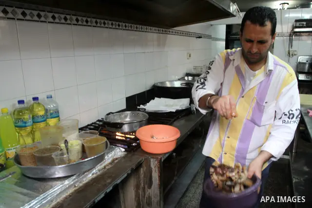 In this photo taken on May 5, 2011: A Palestinian assistant Chef prepares seafood at the Moneer abu Hassira restaurant in Gaza city, ordinary people and politicians alike are served top-class seafood at the Moneer abu Ha...