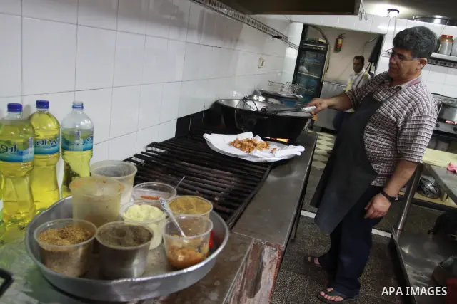 In this photo taken on May 5, 2011: A Palestinian Chef prepares seafood at the Moneer abu Hassira restaurant in Gaza city, ordinary people and politicians alike are served top-class seafood at the Moneer abu Hassira rest...