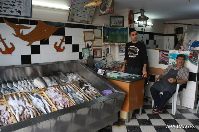 In this photo taken on May 5, 2011: A Palestinian vendor displays fish at the Moneer abu Hassira restaurant in Gaza city, ordinary people and politicians alike are served top-class seafood at the Moneer abu Hassira resta...