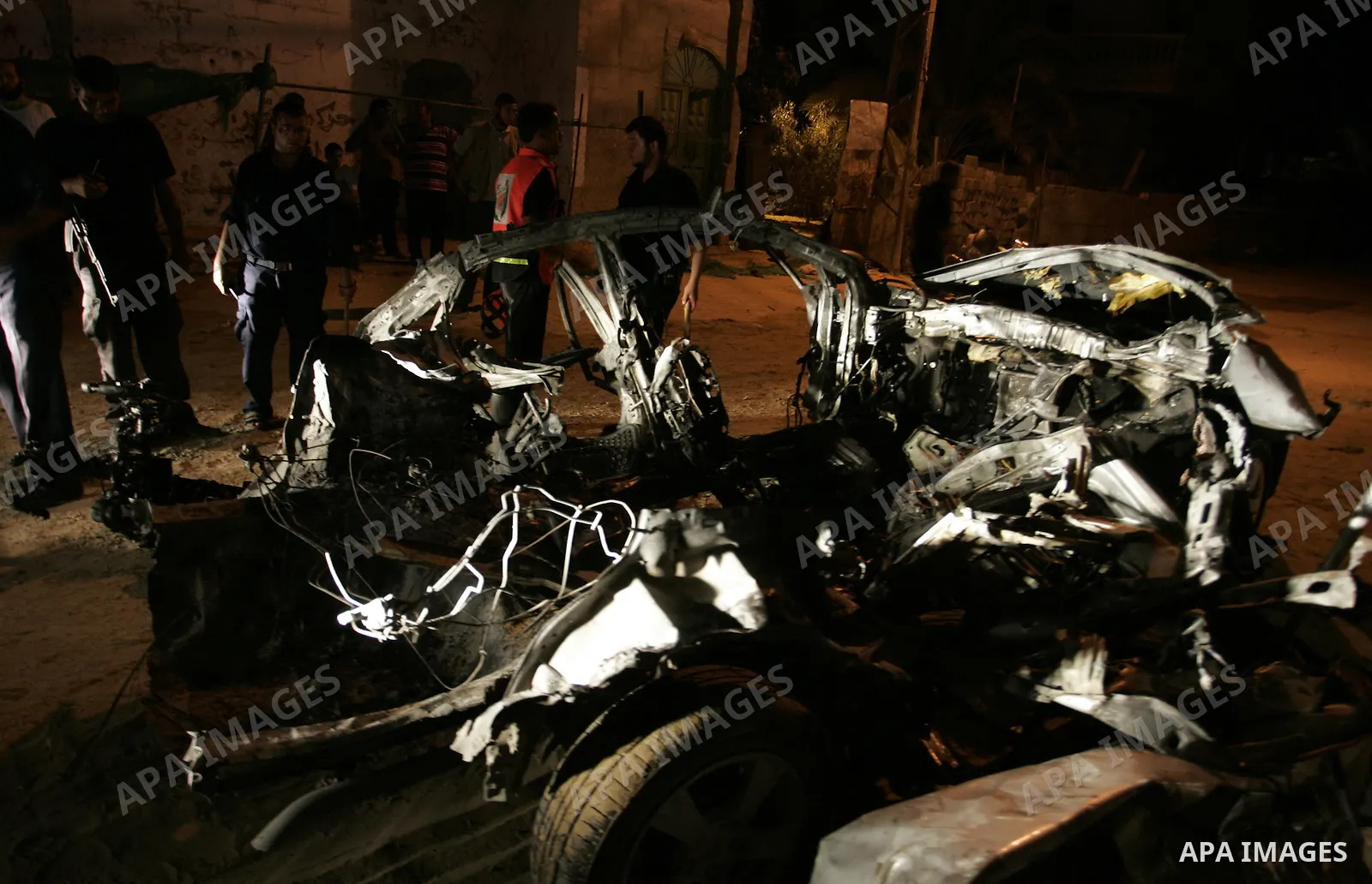 Palestinians look at the wreckage of a car after it was hit by an Israeli missile, killing an Islamic Jihad militant in Rafah, southern Gaza Strip, early Wednesday, Aug. 24, 2011. The Israeli military said the gunman had...