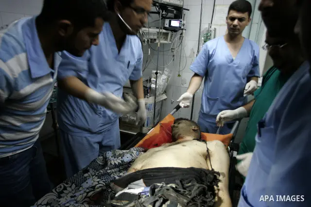 Palestinian medics treat seriously wounded Islamic Jihad militant Ismail Al Asmar, who later died of wounds sustained in an Israeli air strike on his car in Rafah, southern Gaza Strip, Wednesday, Aug. 24, 2011. The Israe...