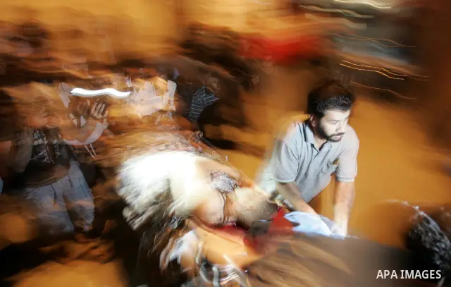 Palestinian medics treat seriously wounded Islamic Jihad militant Ismail Al Asmar, who later died of wounds sustained in an Israeli air strike on his car in Rafah, southern Gaza Strip, Wednesday, Aug. 24, 2011. The Israe...
