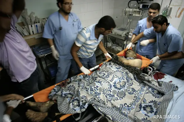 Palestinian medics treat seriously wounded Islamic Jihad militant Ismail Al Asmar, who later died of wounds sustained in an Israeli air strike on his car in Rafah, southern Gaza Strip, Wednesday, Aug. 24, 2011. The Israe...