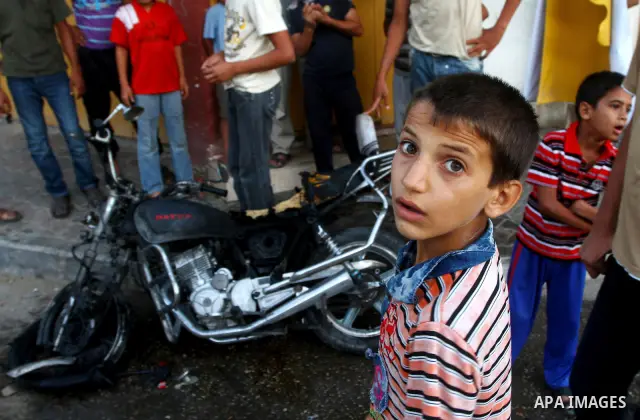 Palestinians inspect a motorcycle damaged in an Israeli air strike in Deir al-Balah in the central Gaza Strip on August 24, 2011. An Israeli strike killed Ismael al-Ismar, 34, in Rafah scarcely 48 hours after militant fa...