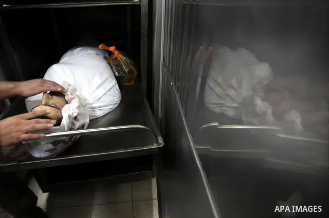 Palestinian relatives mourn over the body of Islamic Jihad militant Ismael Al-Asmar at Rafah hospital after an Israeli air strike hit his car in Rafah in the southern Gaza Strip on 24 August 2011. Al-Asmar, one of the mi...