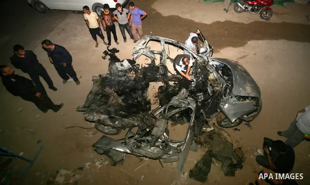 Palestinians check the damage to a car after an Israeli air strike in Rafah in the southern Gaza Strip, on August 24, 2011. Ismael Al-Asmar, one of the militant leaders of the group Islamic Jihad , was killed in the air...