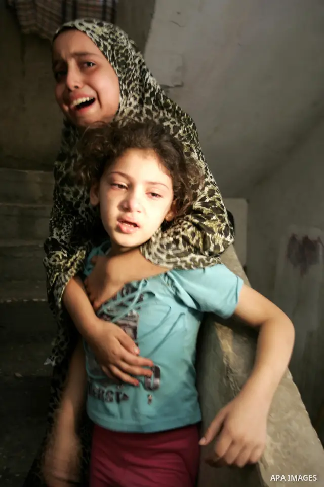 Palestinian relatives mourn over the body of Islamic Jihad militant Ismael Al-Asmar after an Israeli air strike hit his car in Rafah in the southern Gaza Strip on 24 August 2011. Al-Asmar, one of the militant leaders of...